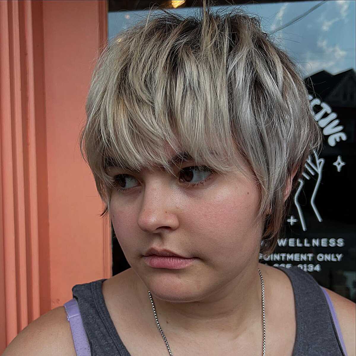 Ash blonde thick pixie shag with heavy eye-skimming fringe