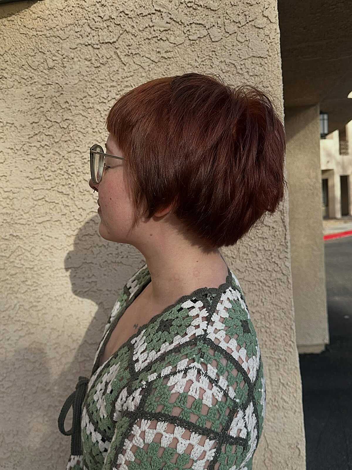 Stacked auburn pixie bob with volume at the crown