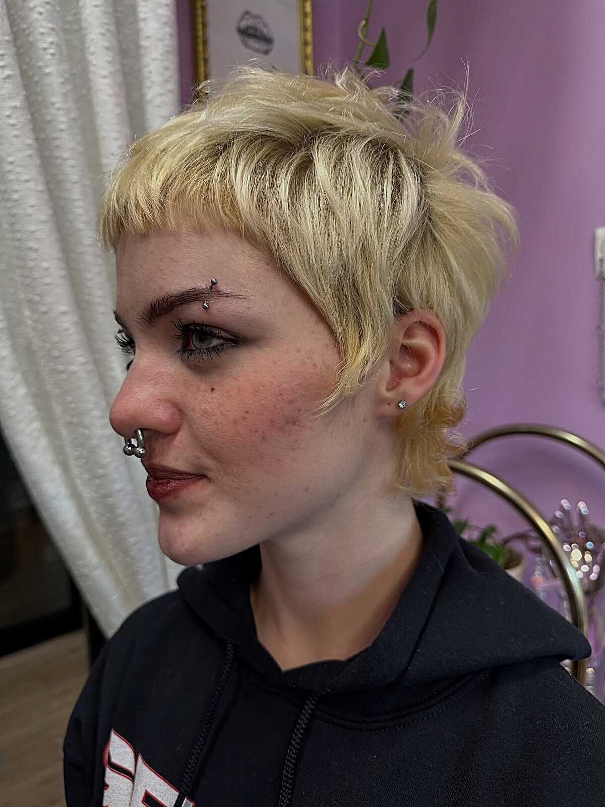 Bleached blonde shaggy pixie cut with choppy layers