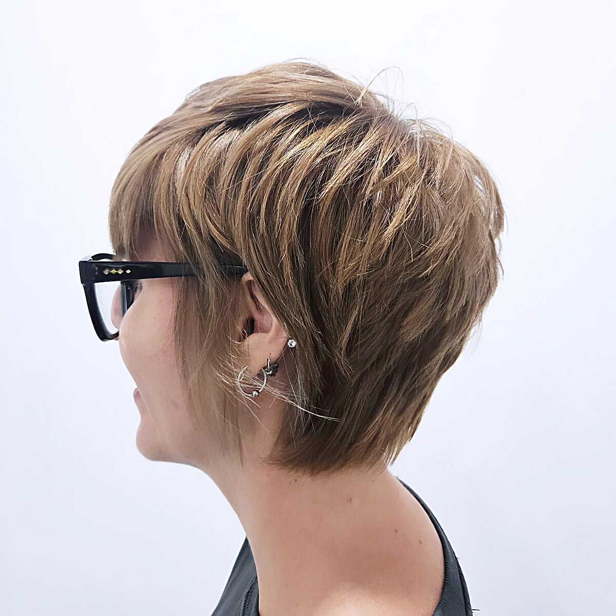Bronde layered pixie with golden highlights from the side