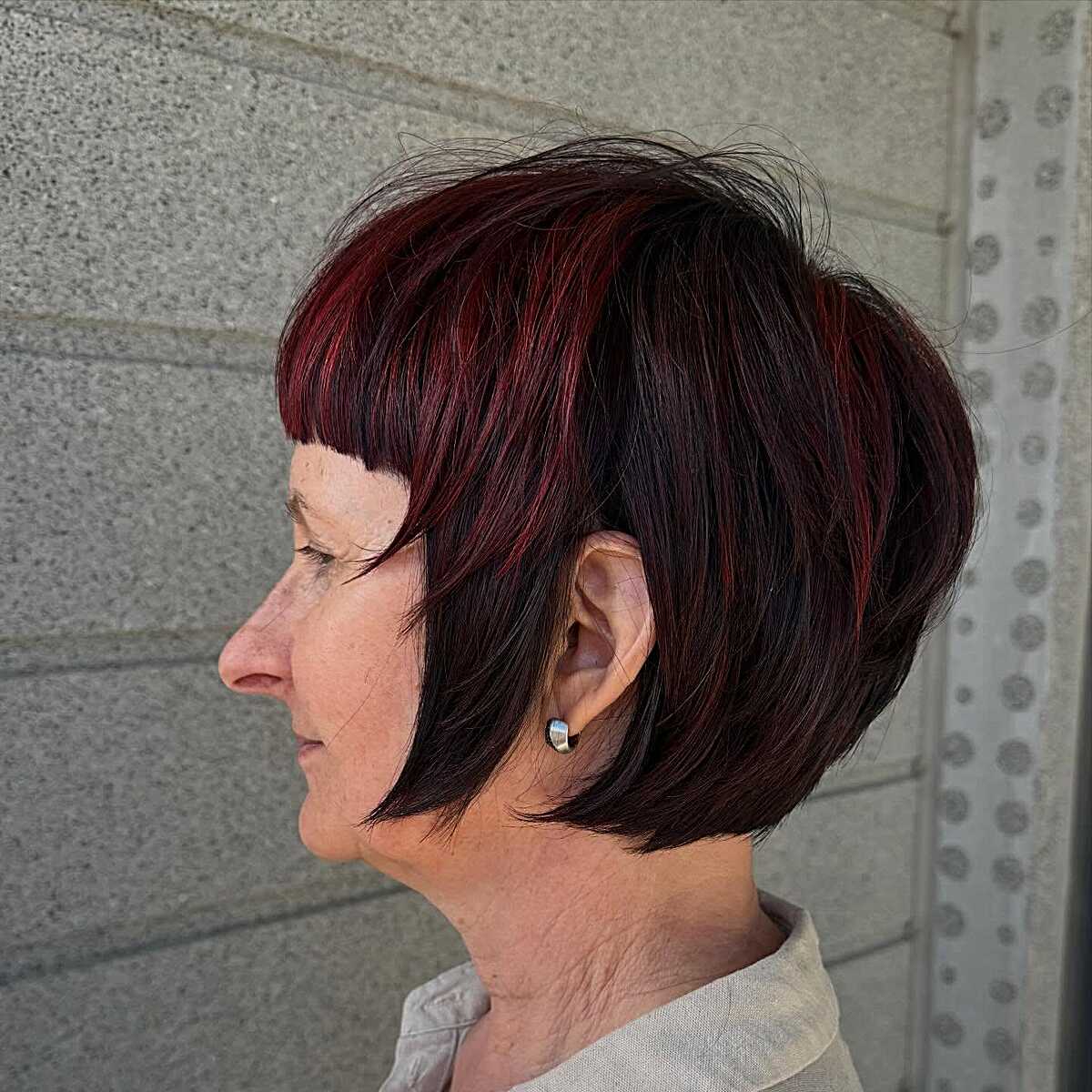 Dark bob with burgundy red highlights and side bangs