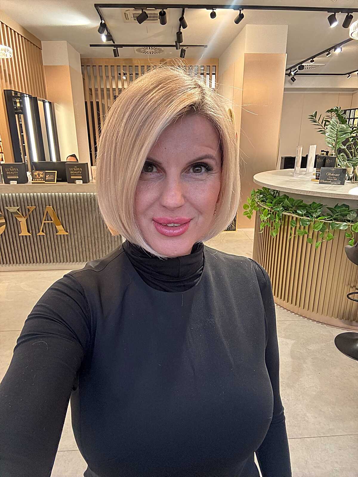Buttery blonde angled chin-length bob with side part
