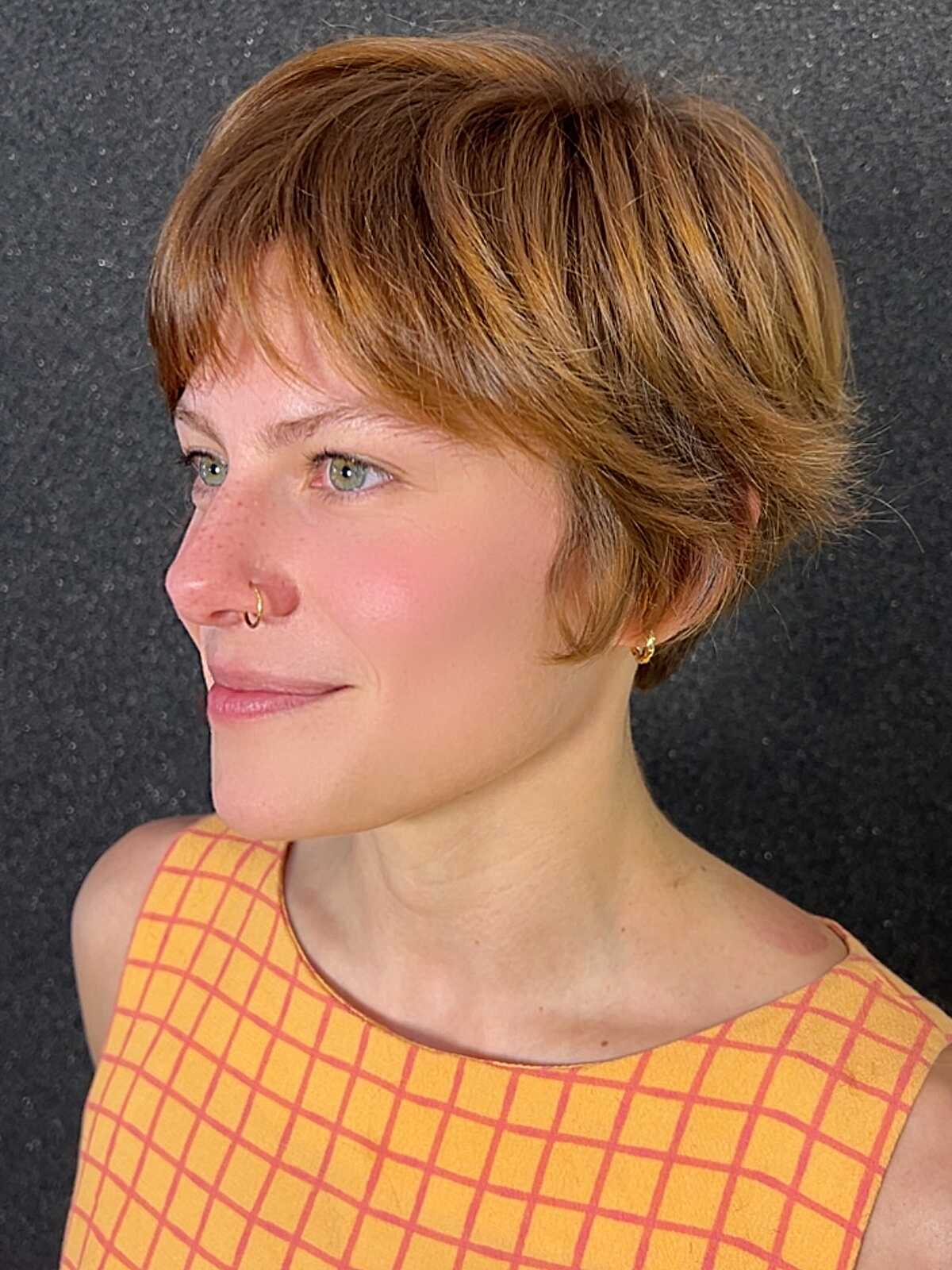 Copper pixie cut with soft wispy fringe on thick hair
