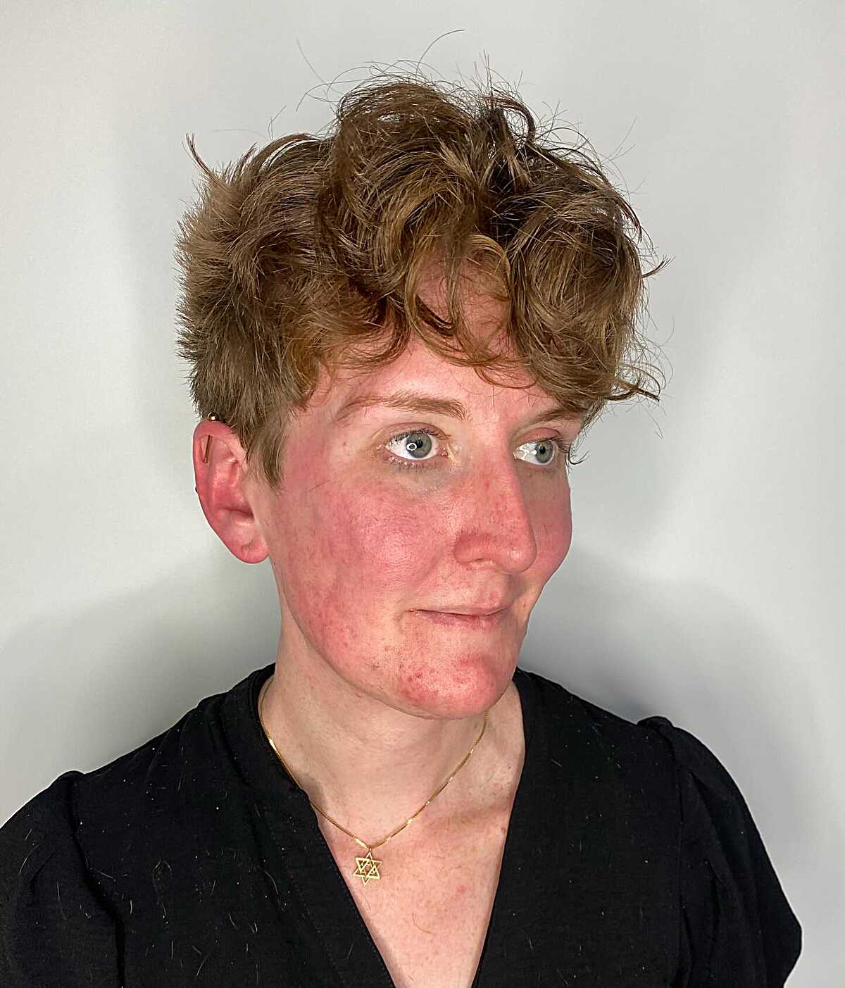 Curly auburn pixie with volume on top and short sides