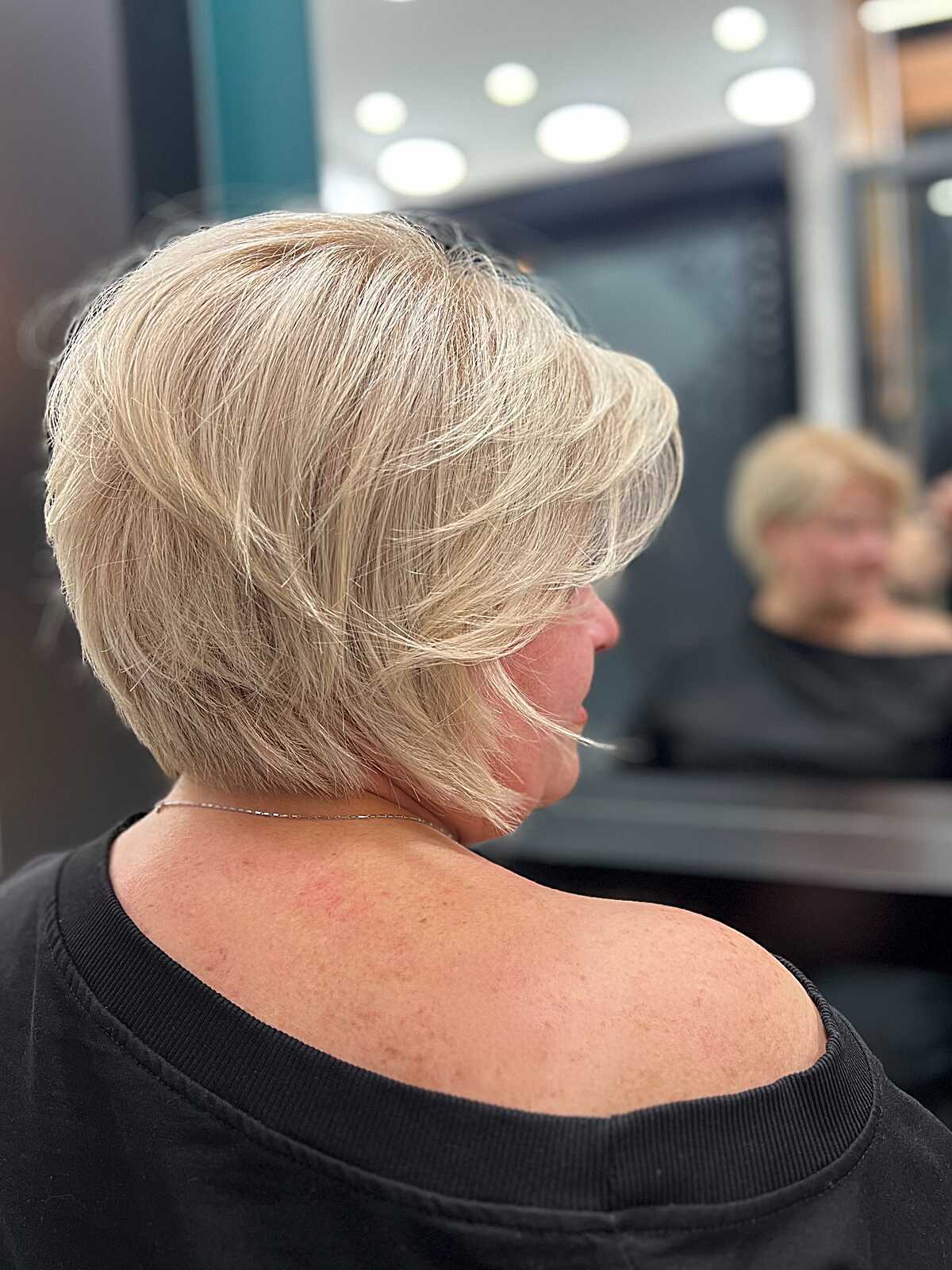 Feathered layered champagne blonde bob from the back
