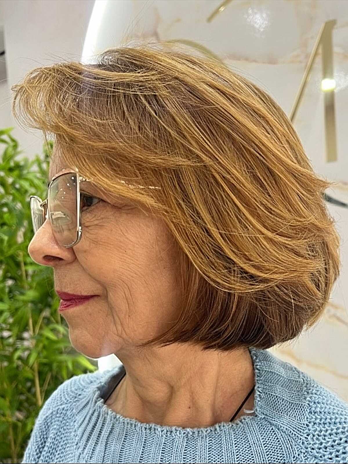 Honey caramel chin bob with flipped ends and wispy bangs