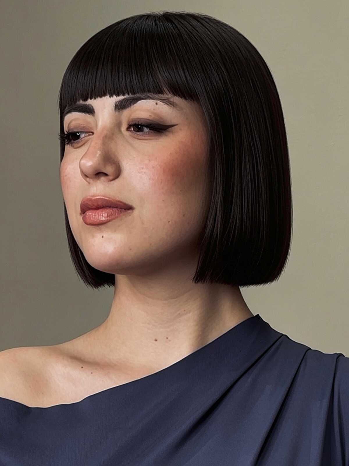 Sleek jet black blunt bob with short baby bangs