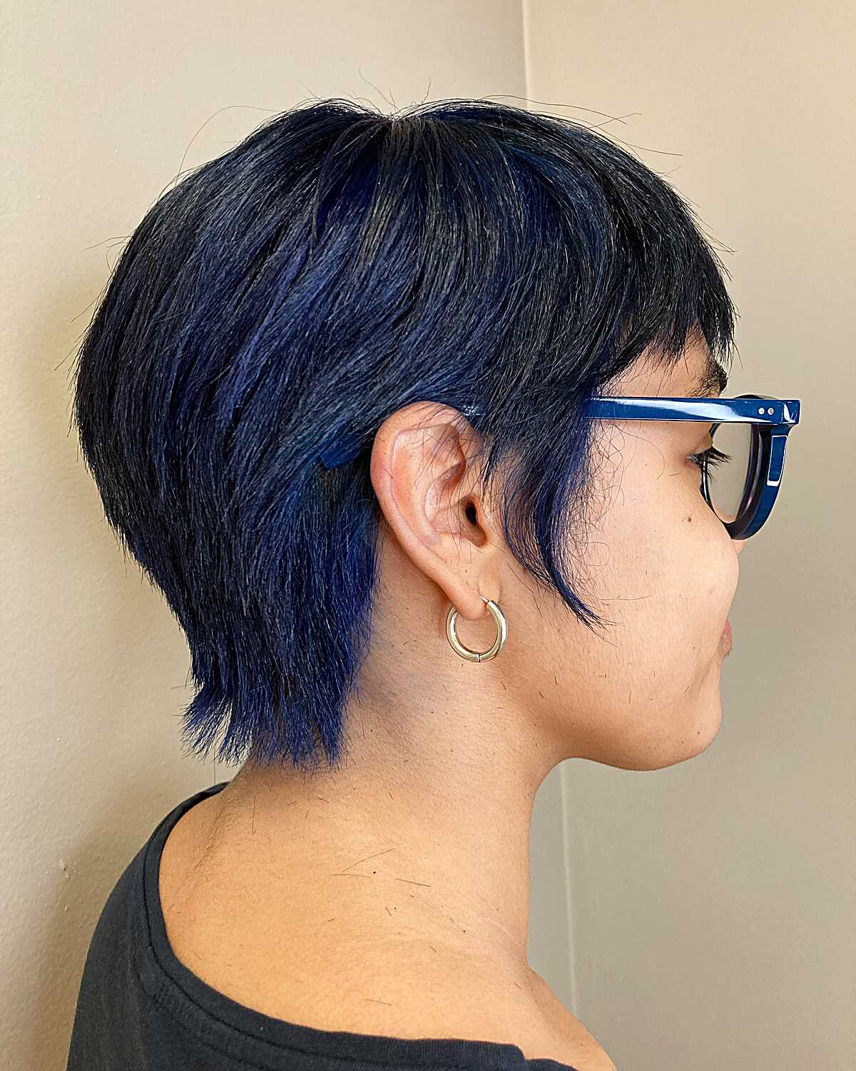 Dark blue-black textured pixie cut with longer nape