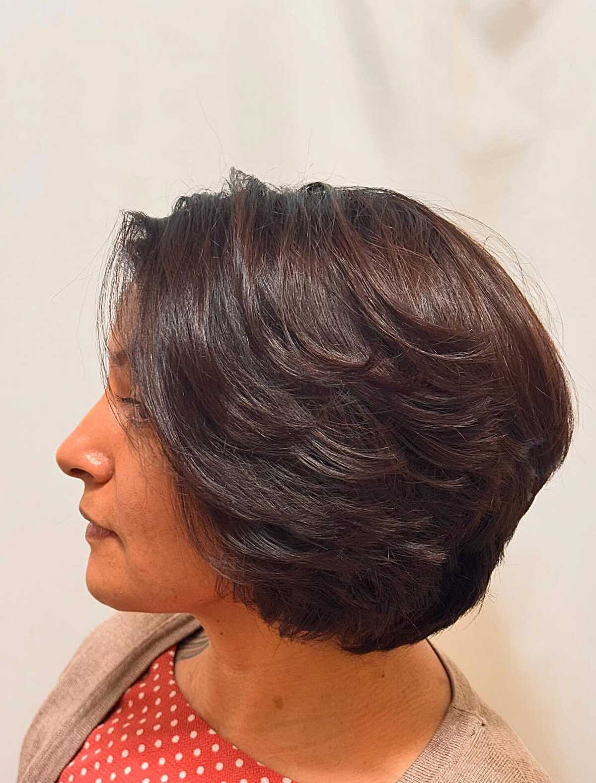 Rich brunette chin bob with layered volume side view