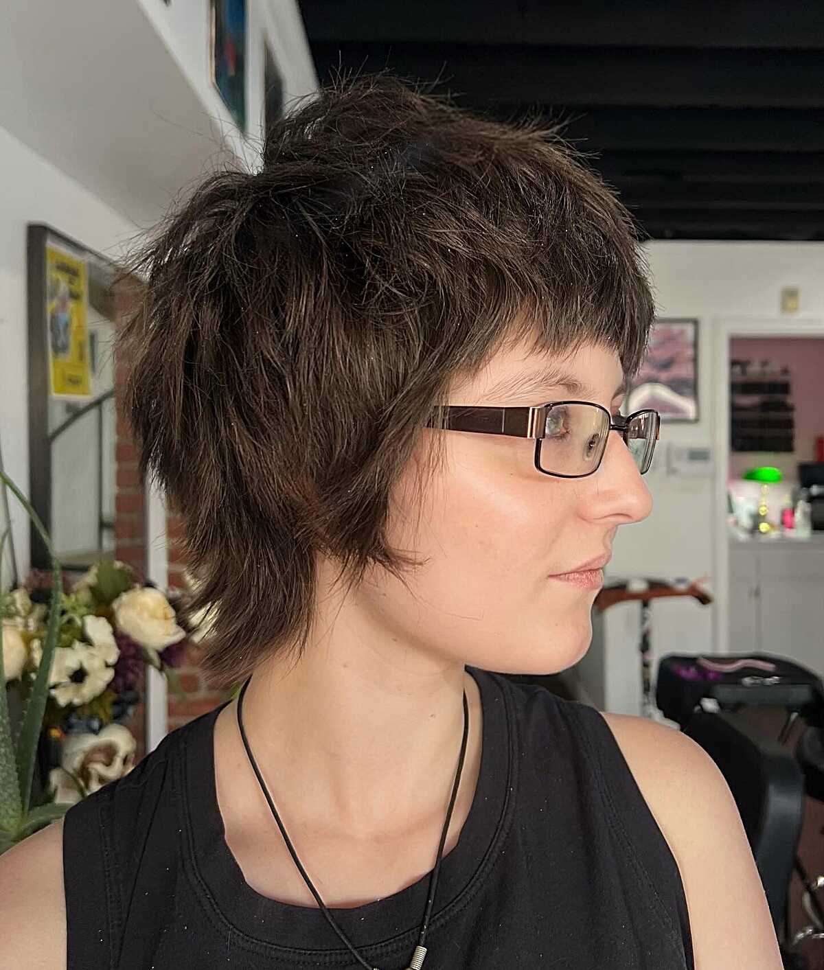 Shaggy dark brown pixie mullet with choppy fringe