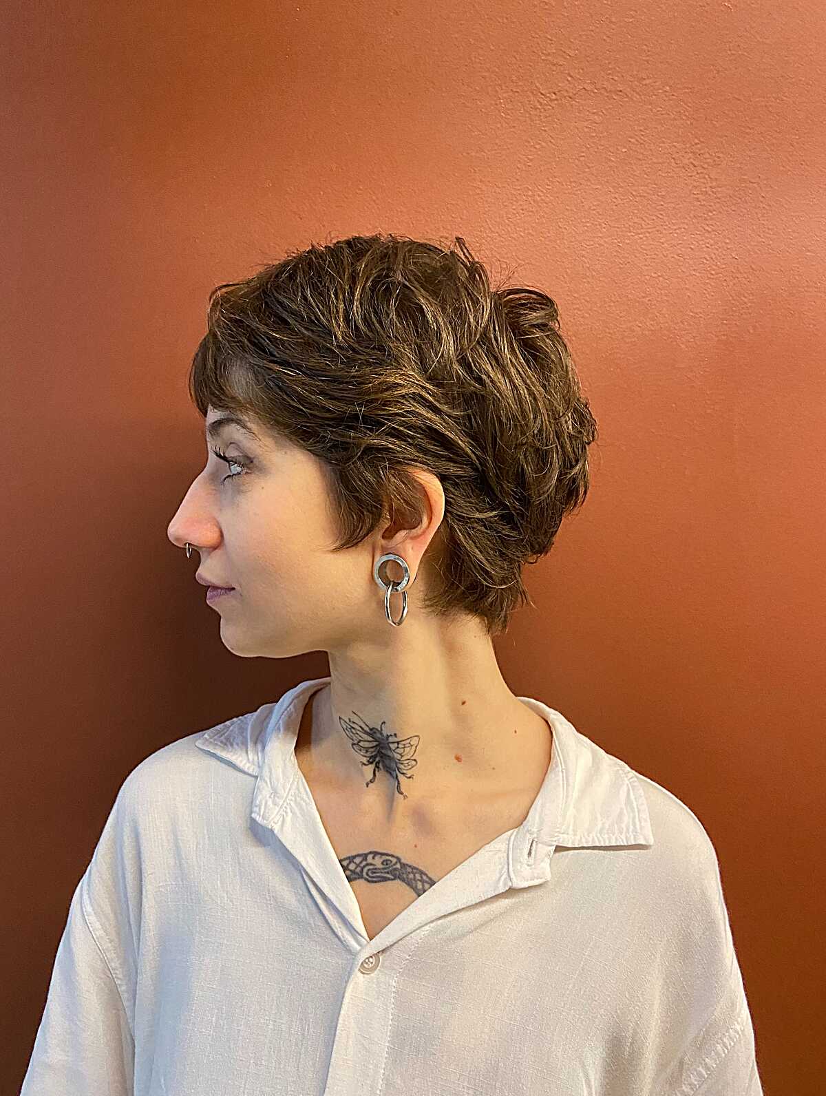 Wavy brown pixie cut showing natural thick texture