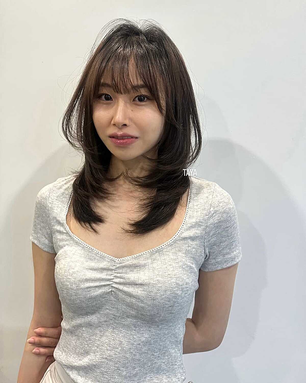 Chocolate brown medium layers with swoopy bangs
