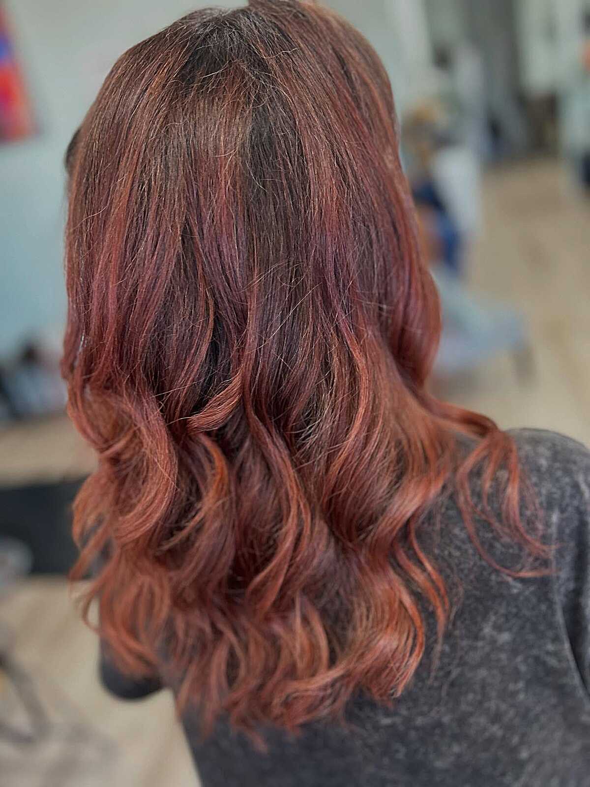 Wavy brown hair melting into warm copper red highlights