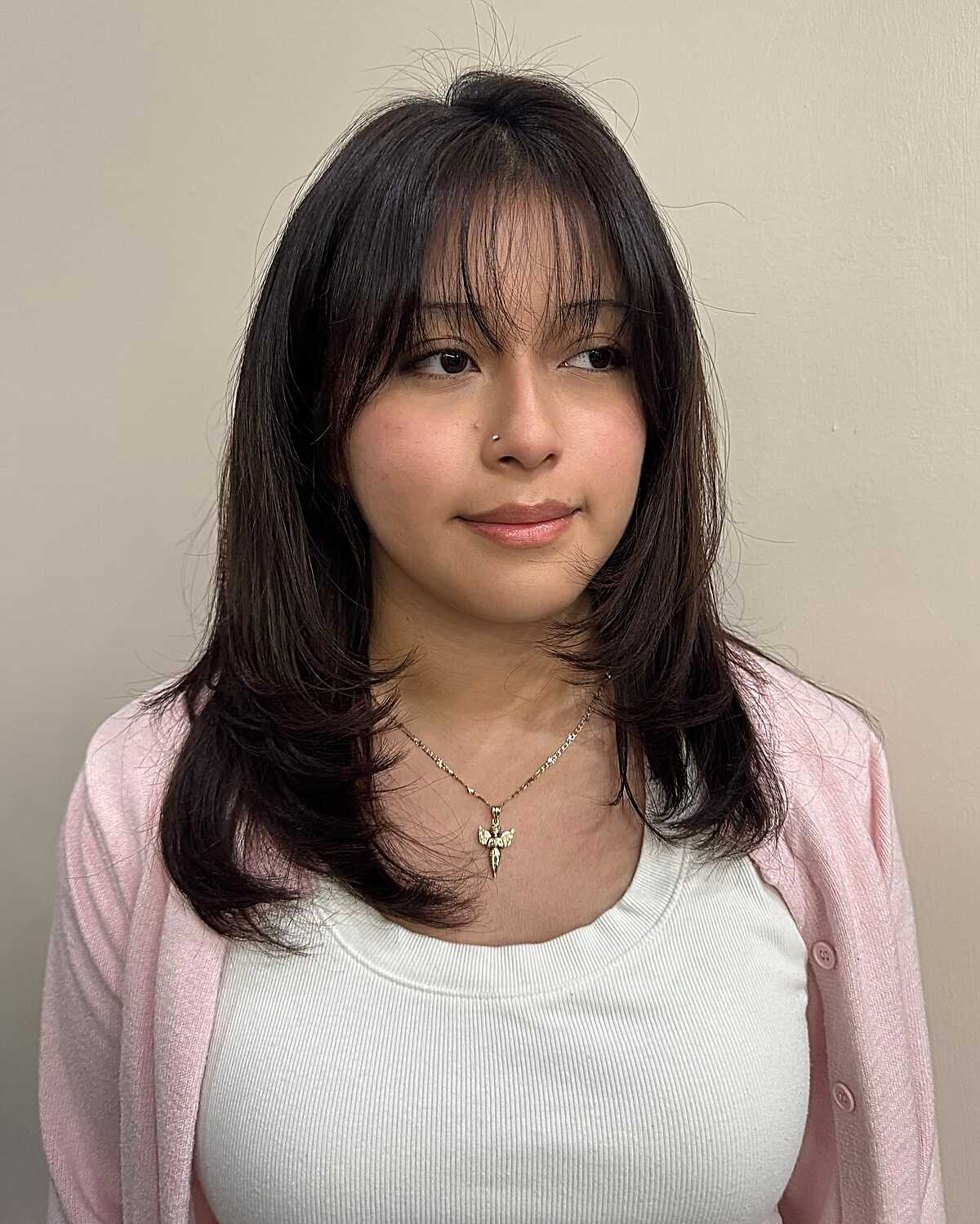 Dark brunette medium layers with soft curtain fringe