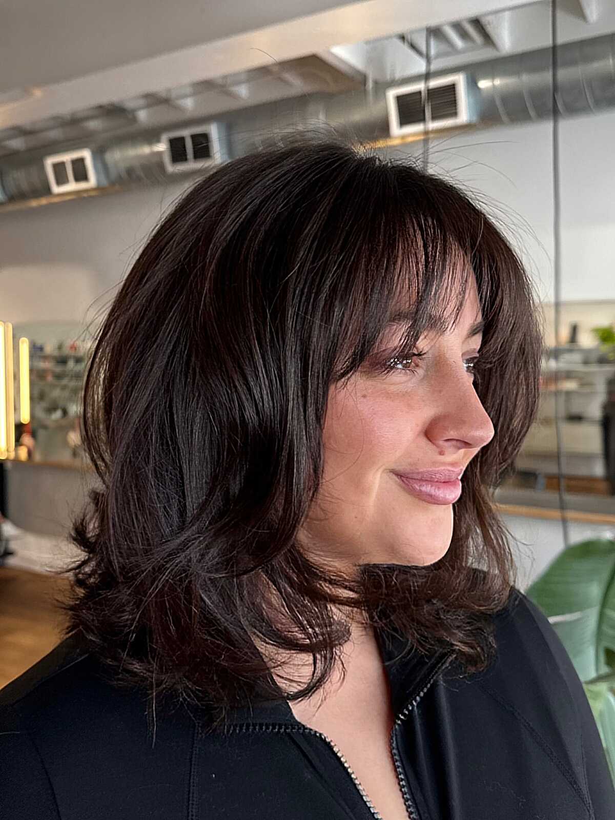 Dark espresso layered bob with full bangs and bouncy ends