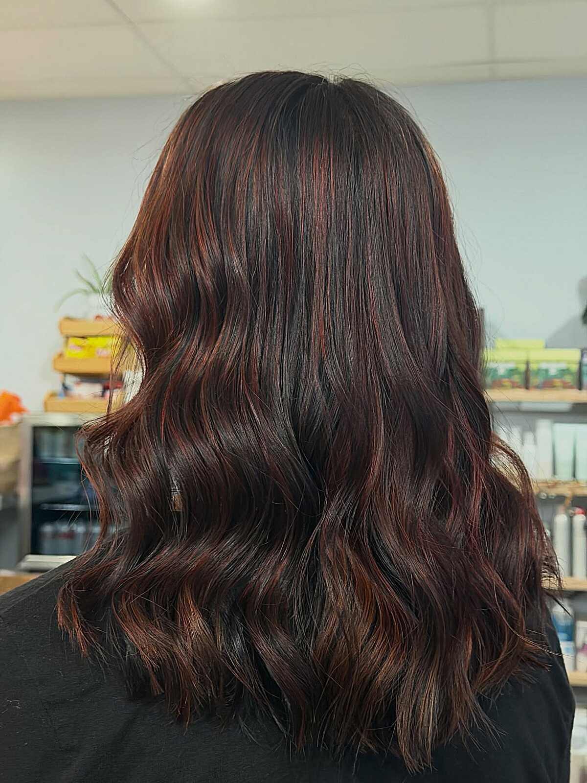Medium wavy dark espresso brown hair with red undertones