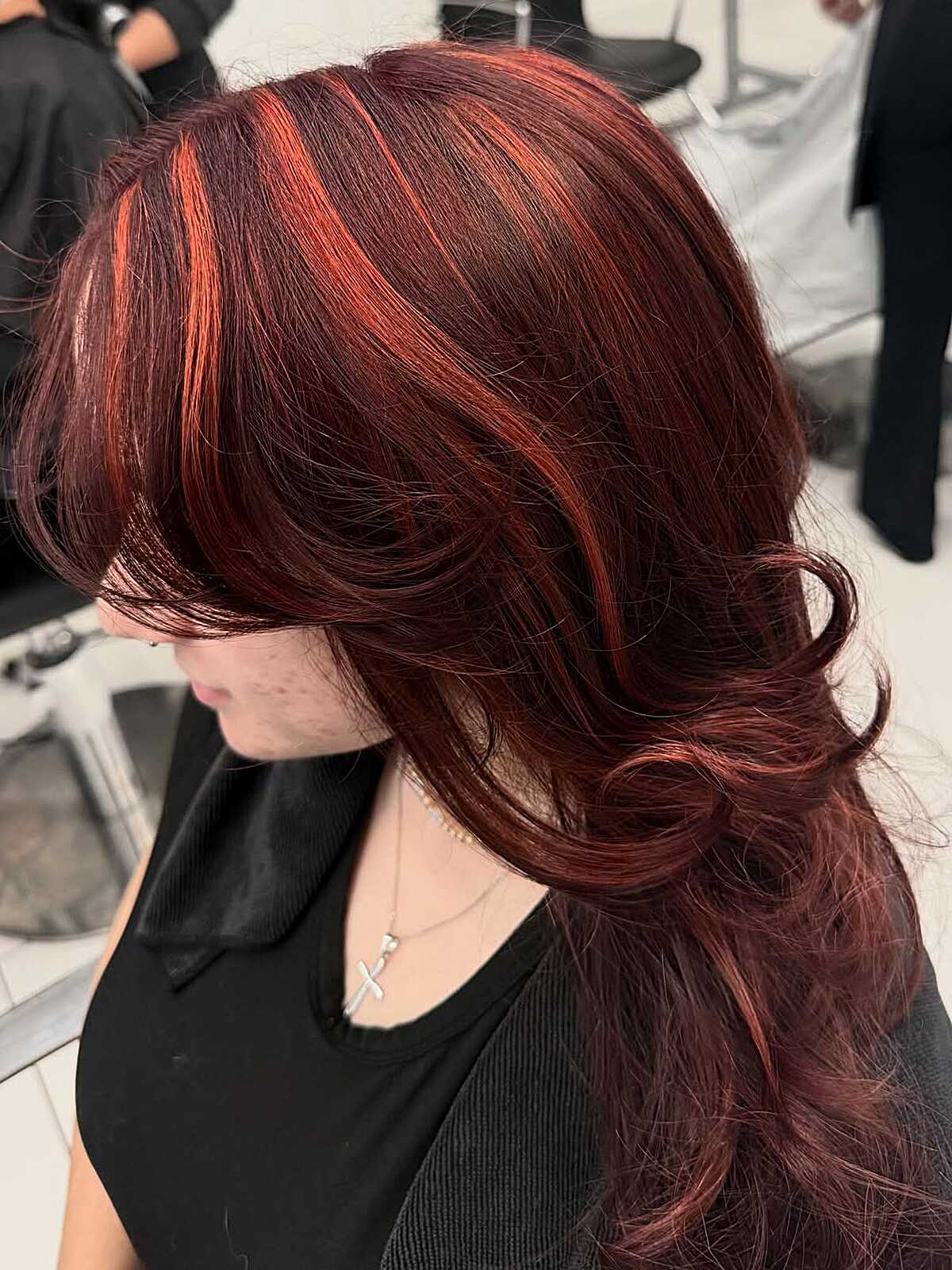Deep burgundy brown hair with bright copper face-framing