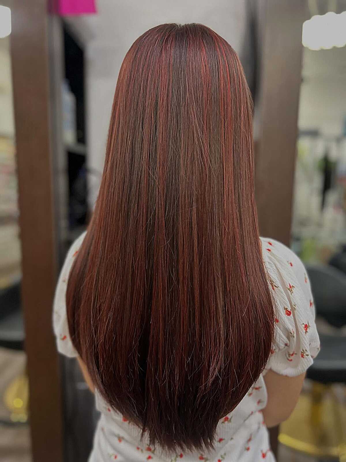 Long straight glossy mahogany hair with red undertones