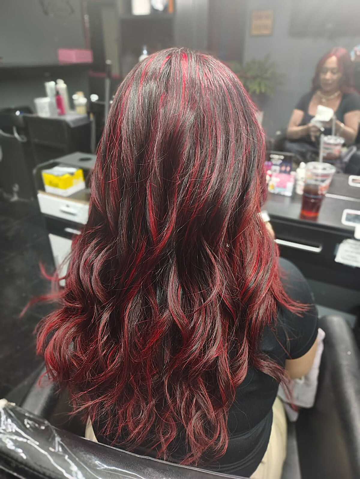 Long dark brown hair with vivid crimson red highlights