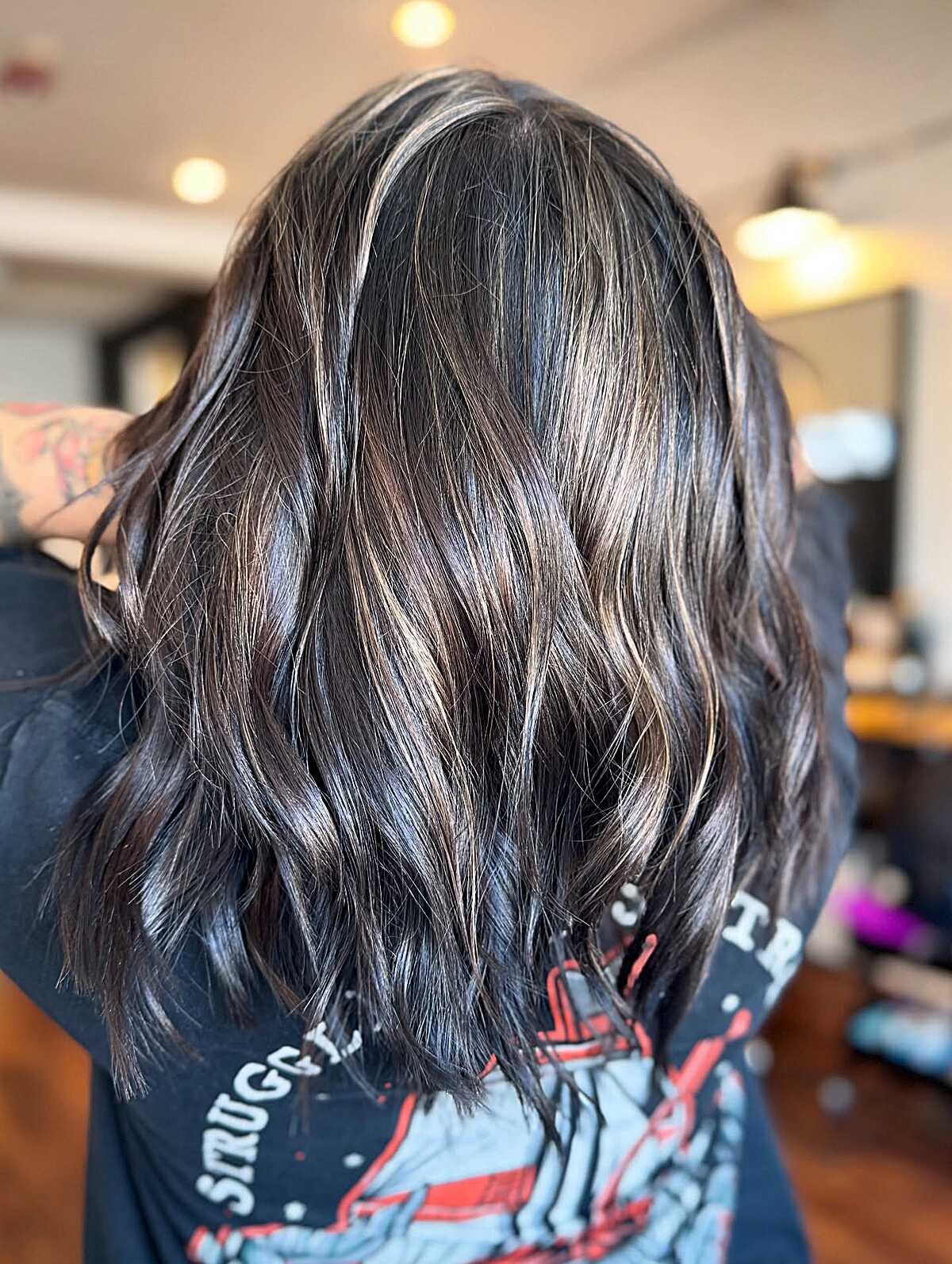 Ashy babylights woven through dark chocolate wavy lob