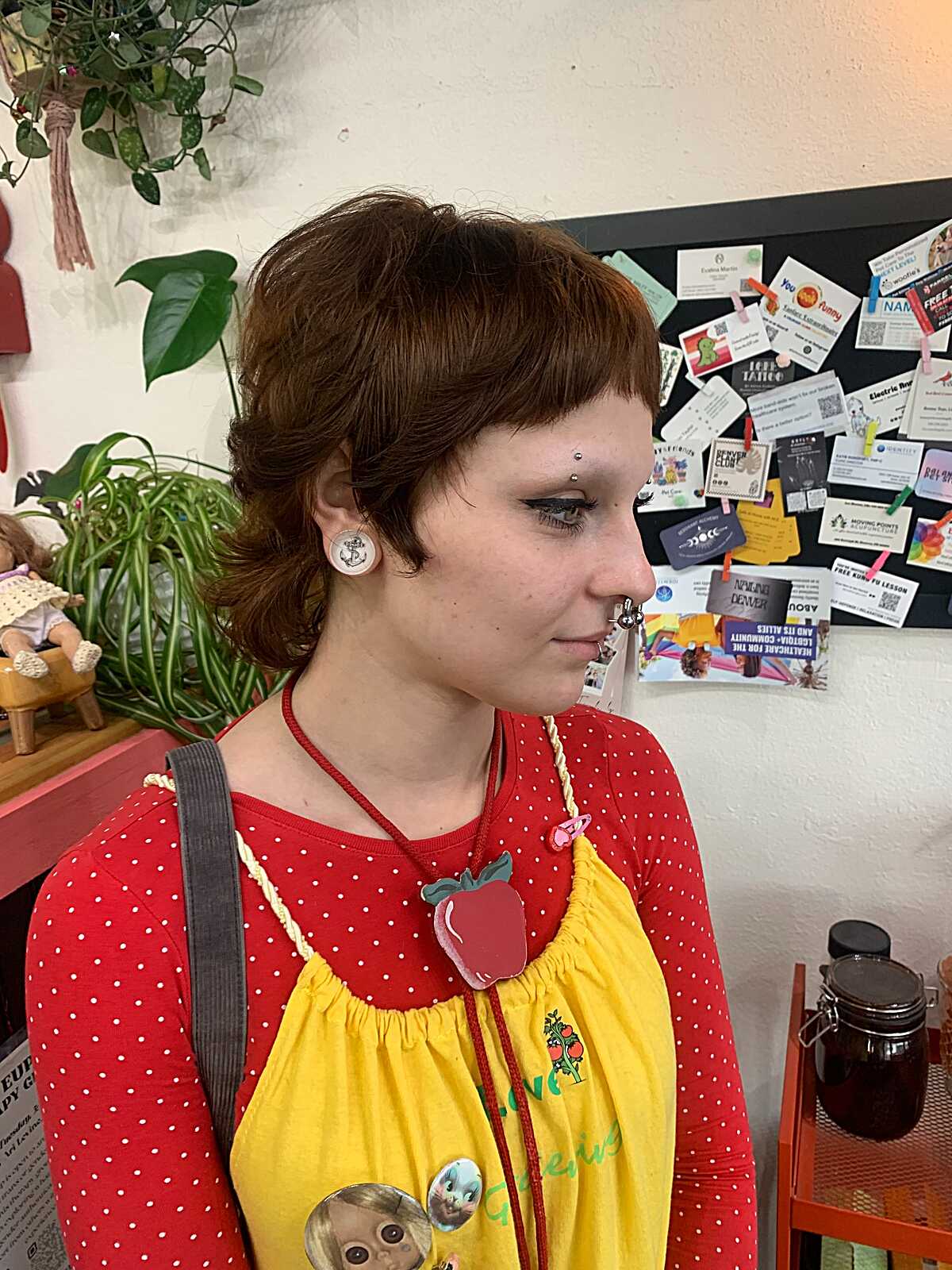 Auburn pixie mullet with short top and curled nape length