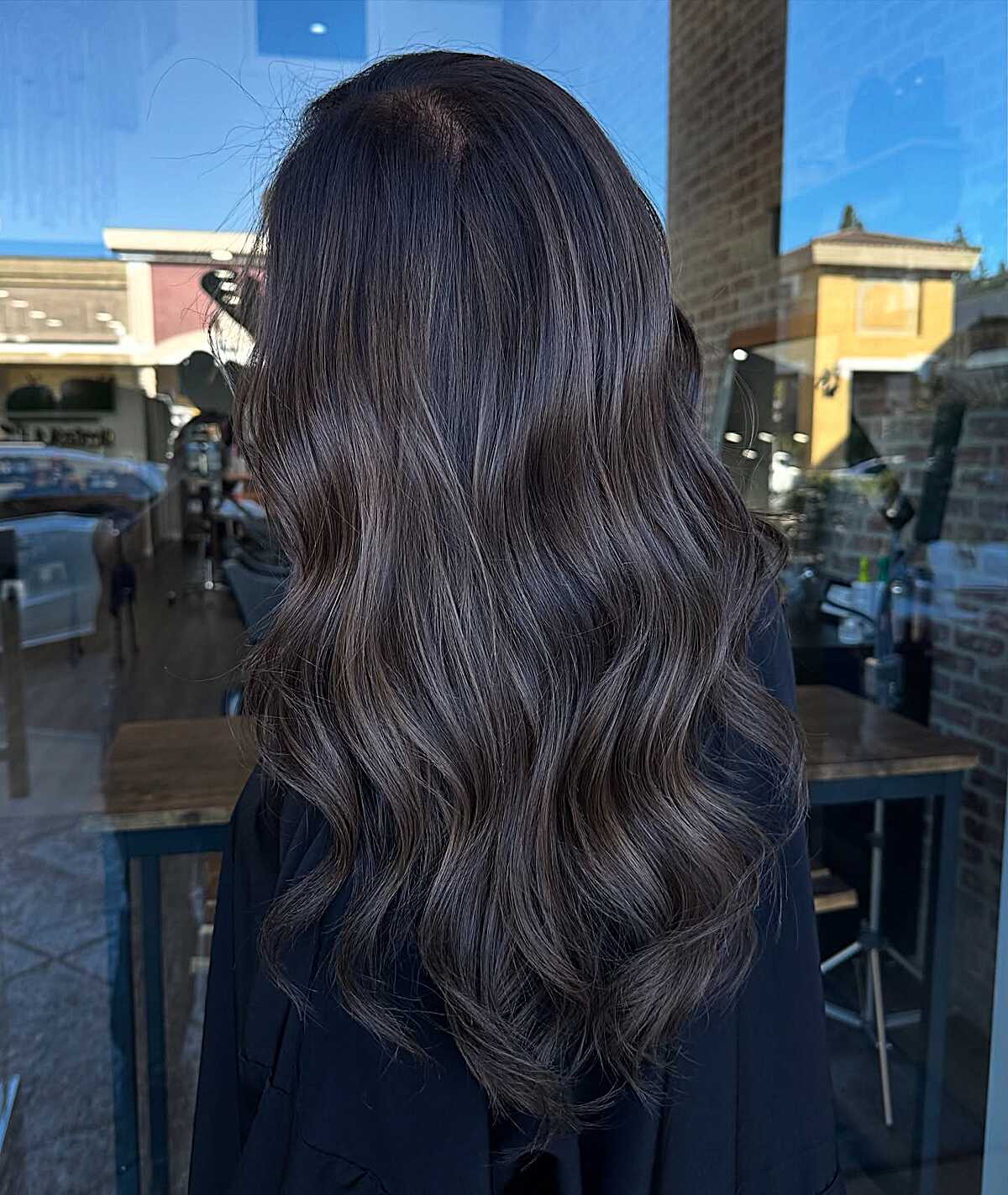 Dark espresso wavy hair with very subtle ash babylights