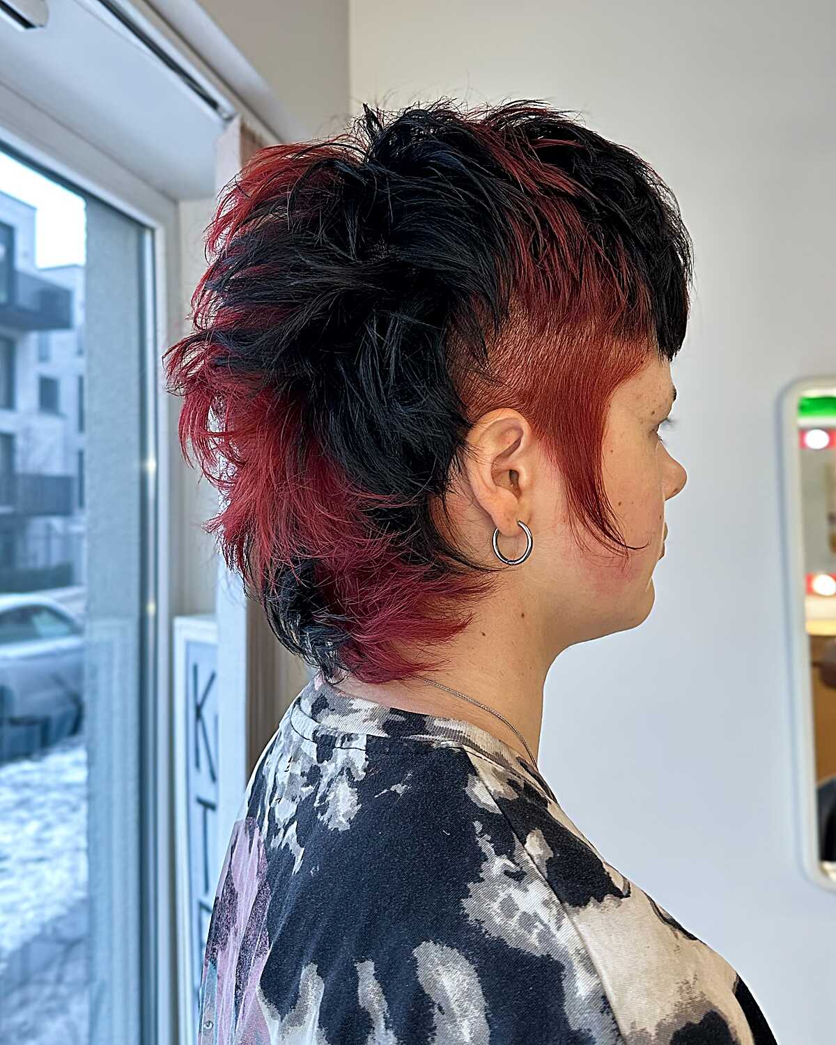 Black and red textured short mohawk-style cut