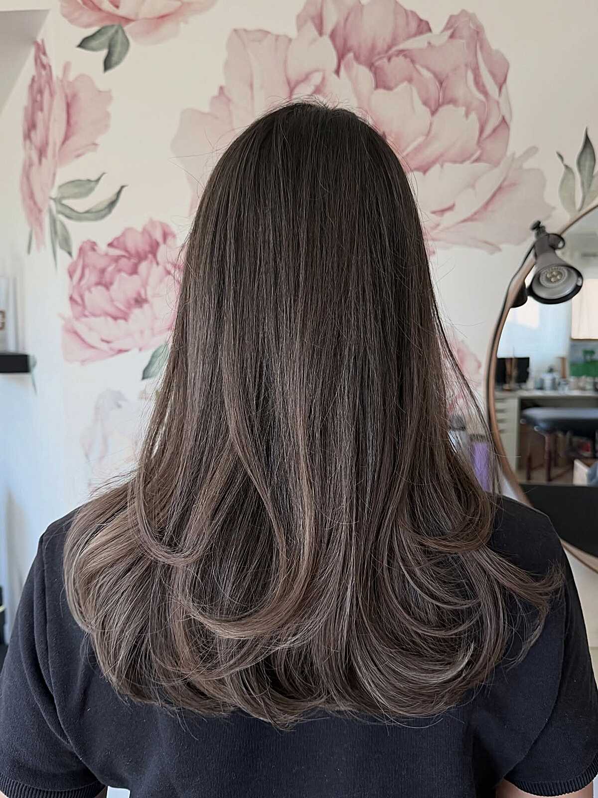 Dark brunette blowout with ashy babylight tips