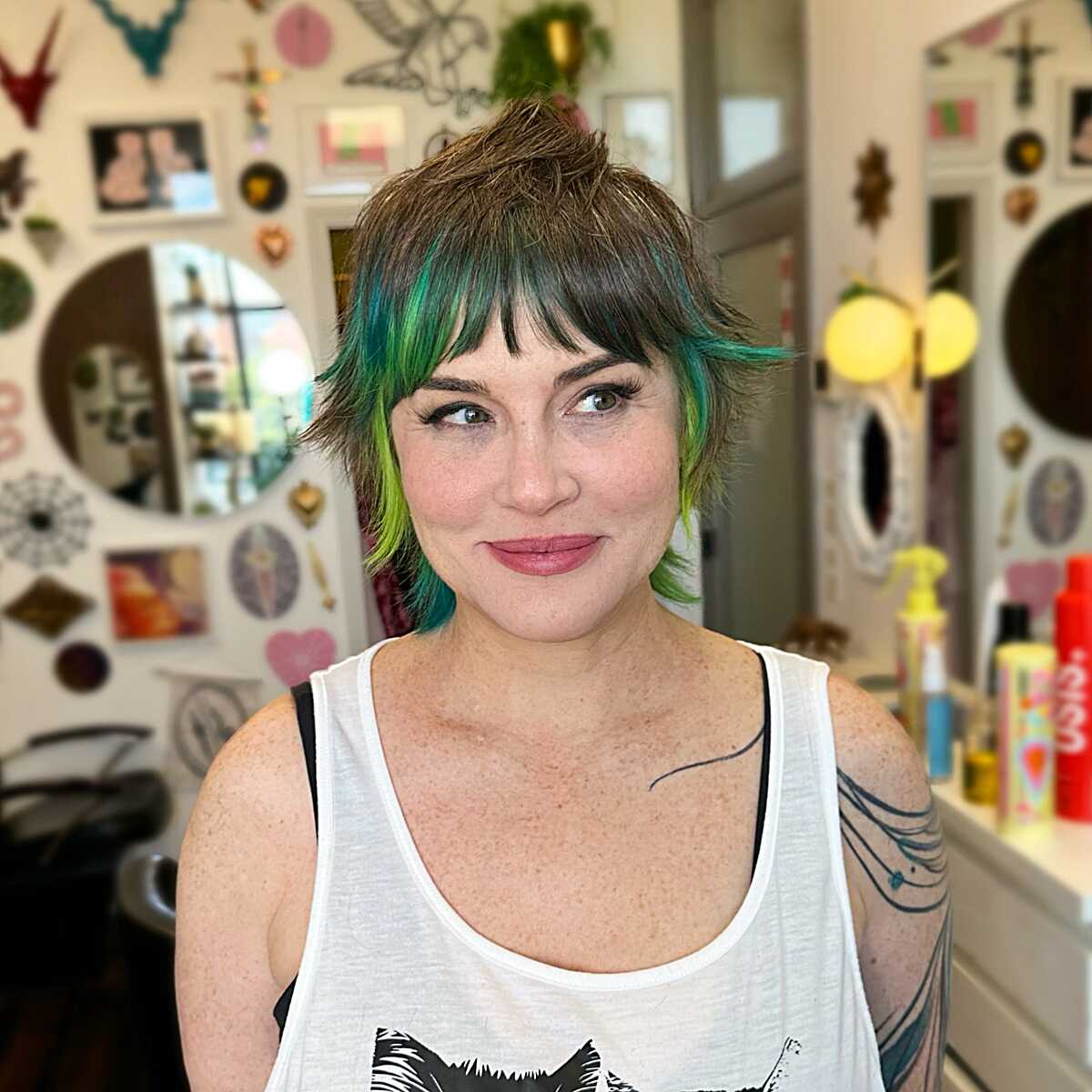Brunette shaggy bob with emerald green peekaboo color
