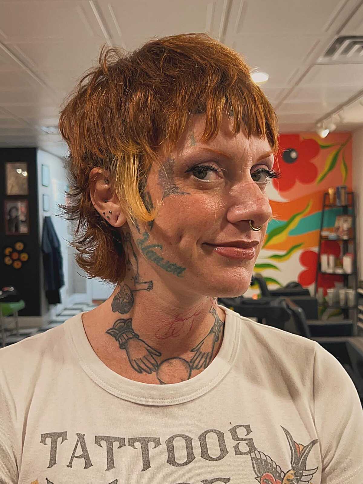 Short copper pixie shag with yellow accent and micro bangs