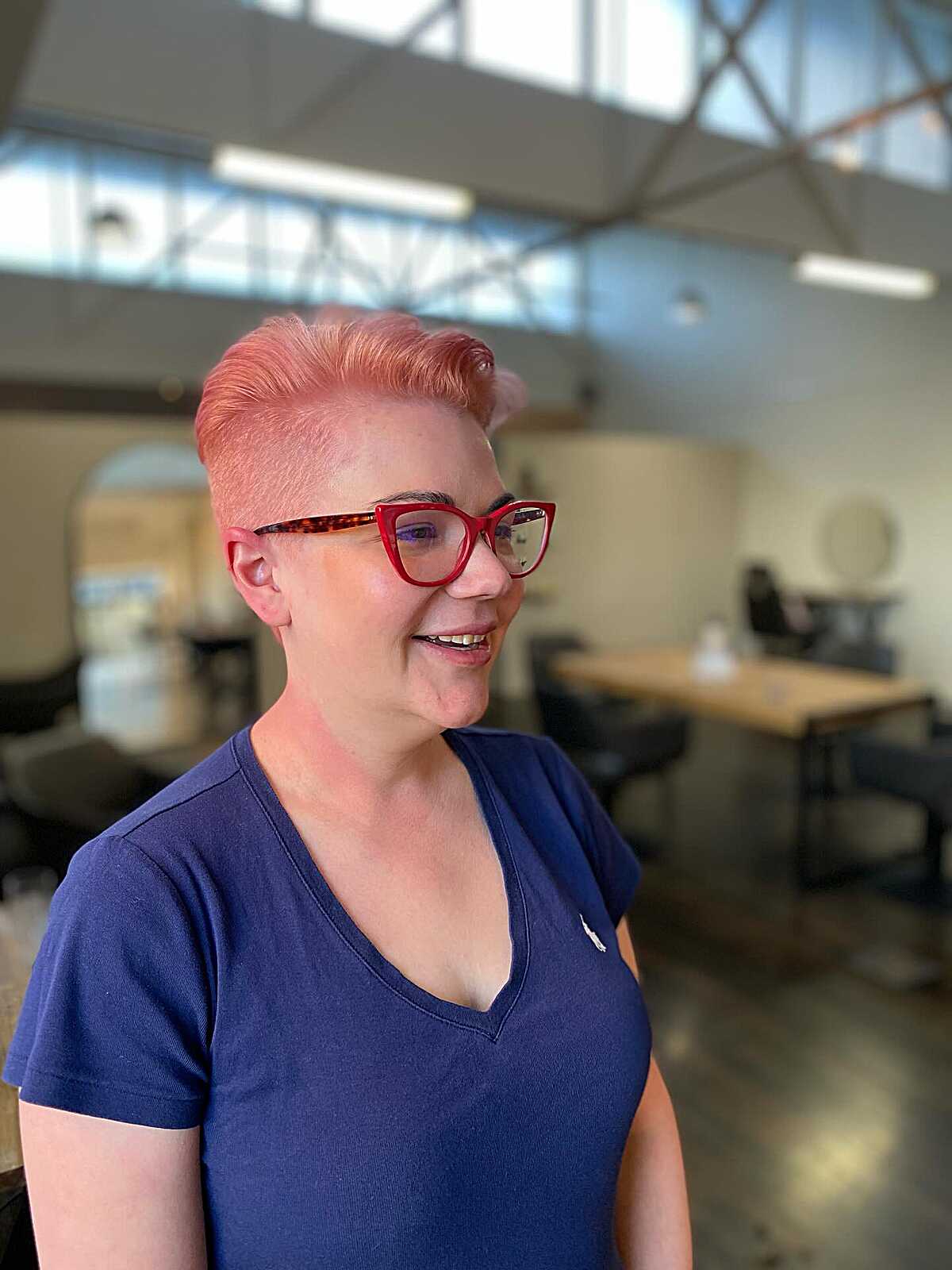 Coral pink pompadour pixie with faded sides and glasses