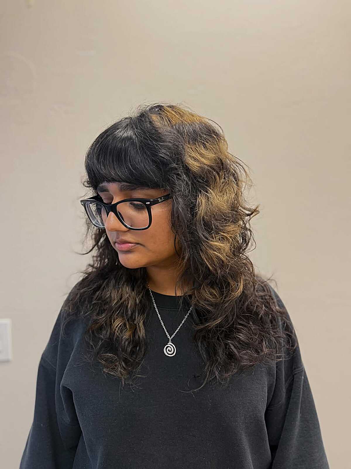 Long curly dark shag with honey blonde face-framing pieces