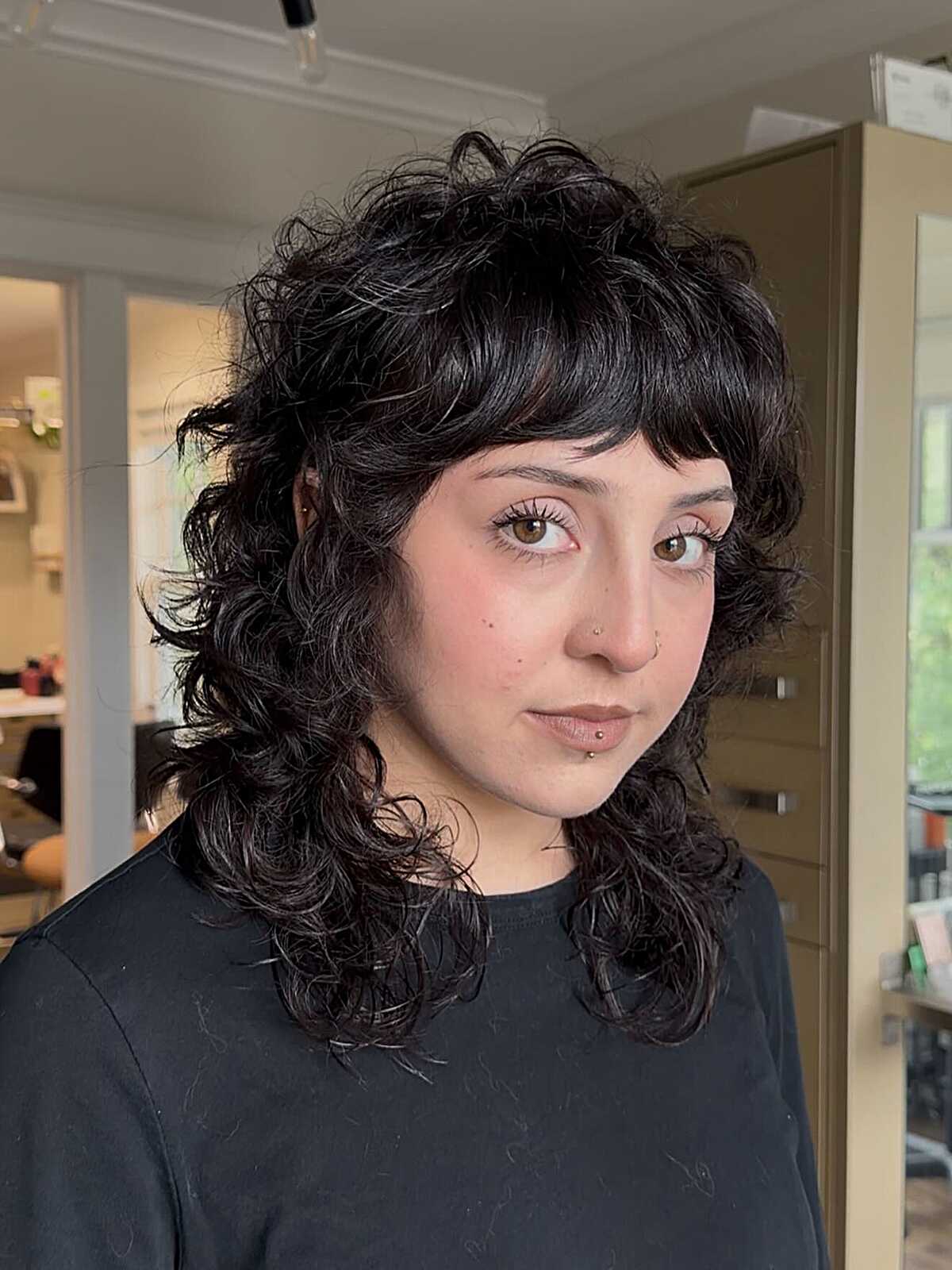 Black curly shag with defined ringlets and curly bangs