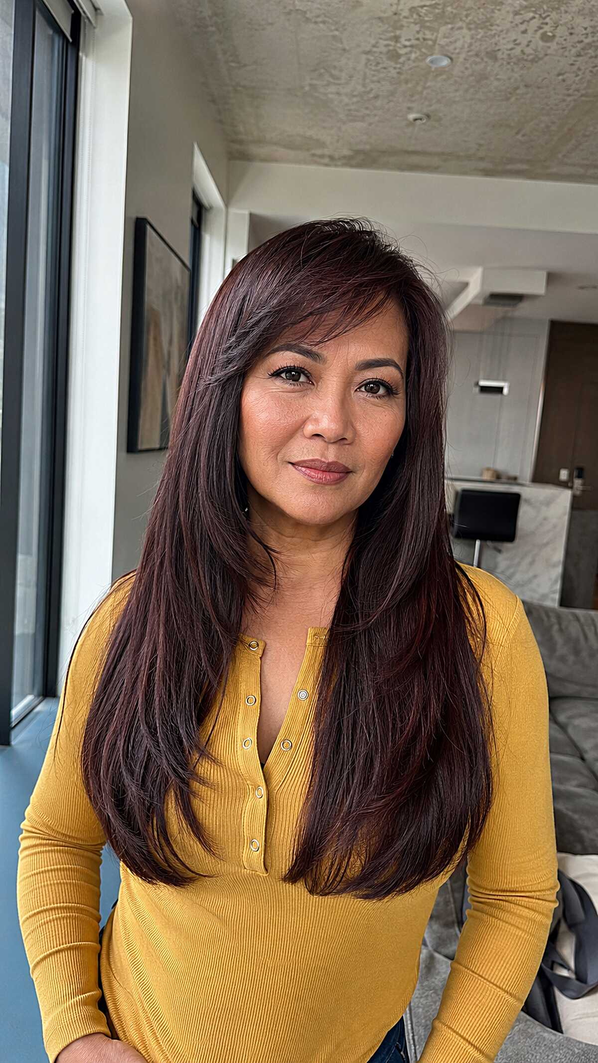 Dark mahogany long straight hair with face-framing sweep