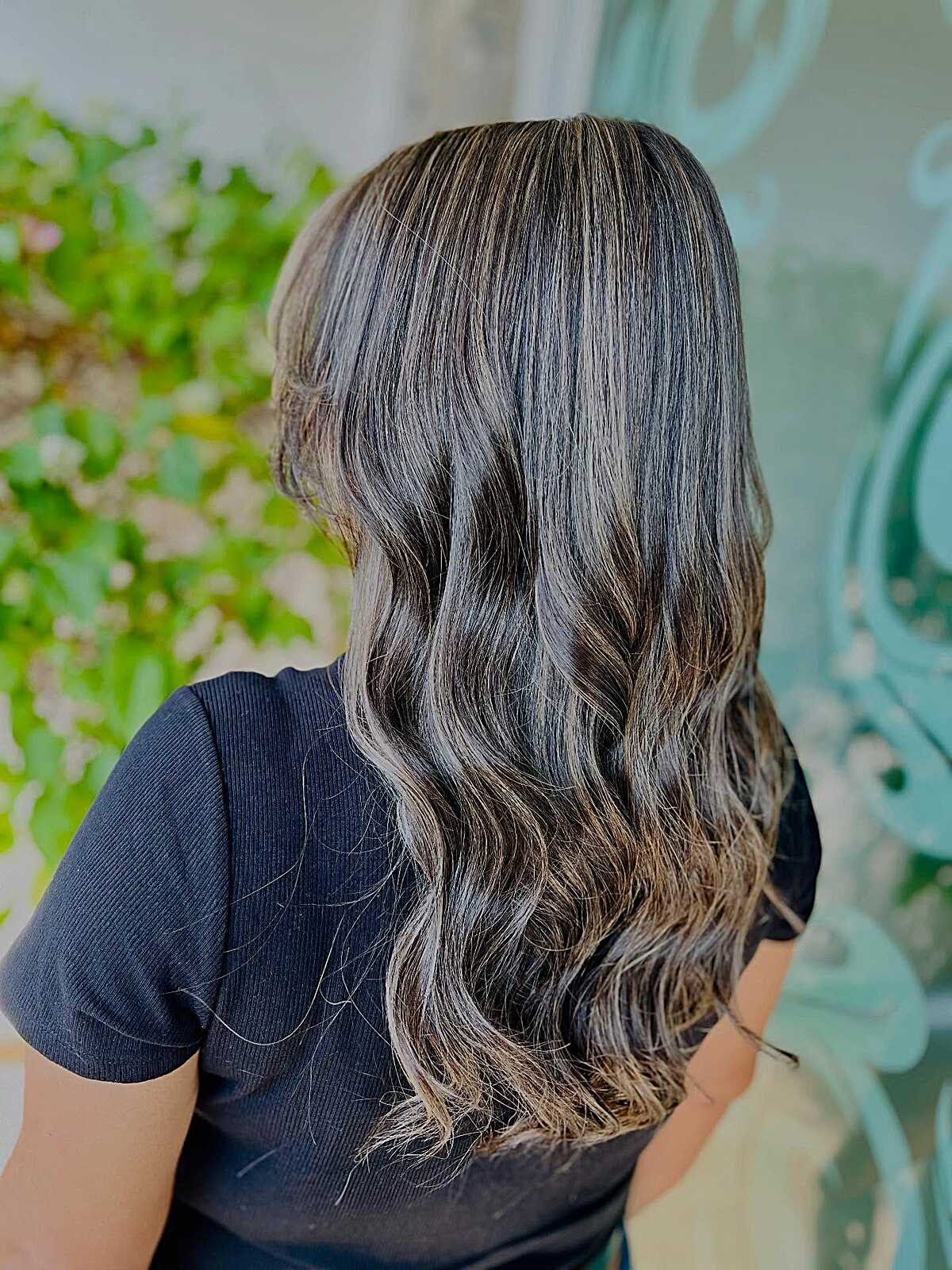 Dark chocolate hair with soft ashy babylights and waves