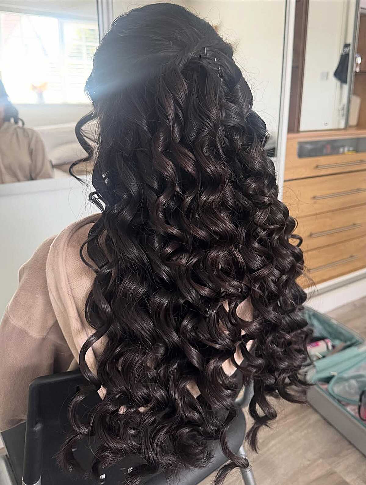 Glossy Jet Black Spiral Curls in Half Up Style