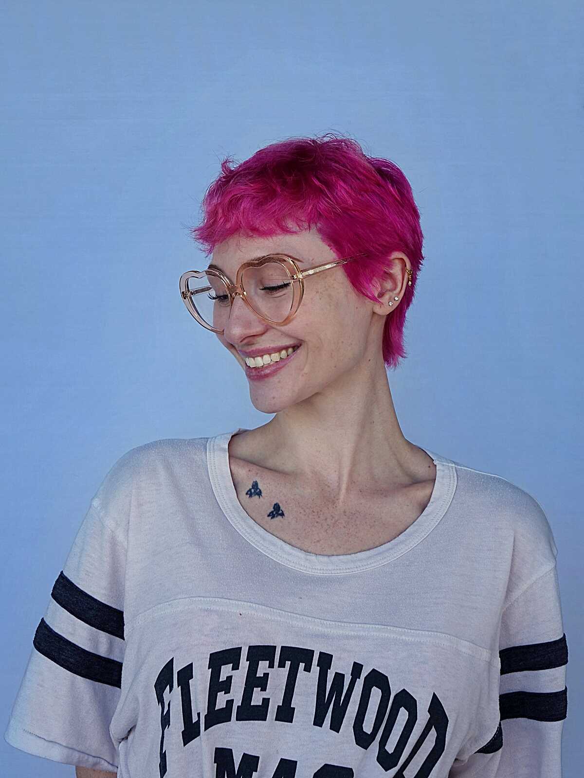Hot pink messy textured pixie cut with glasses