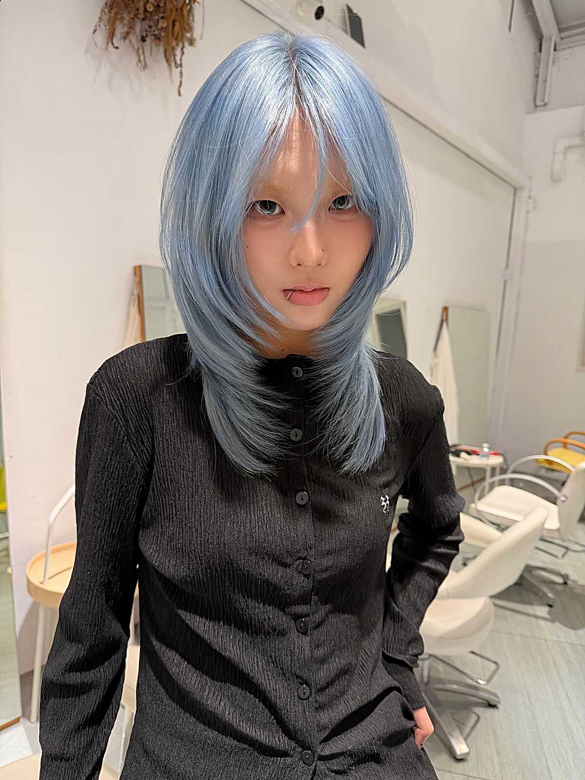 Shoulder-length icy periwinkle blue hush cut with fringe