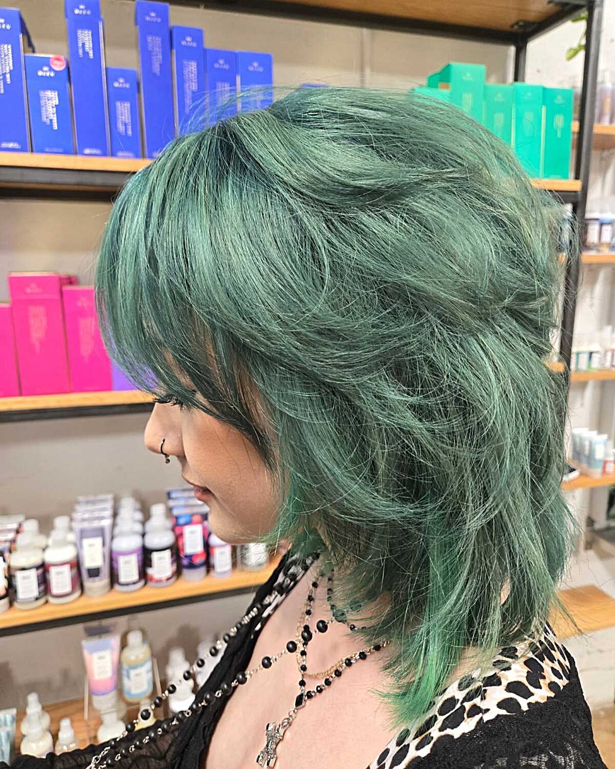 Side view of voluminous jade green shag with bangs