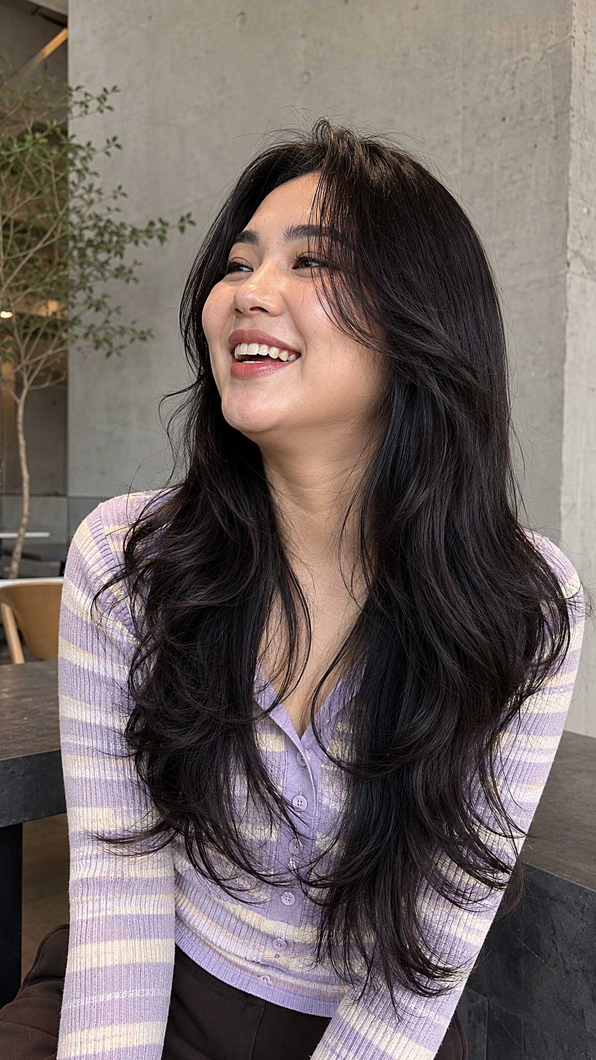 Jet black long wavy layered hair with volume