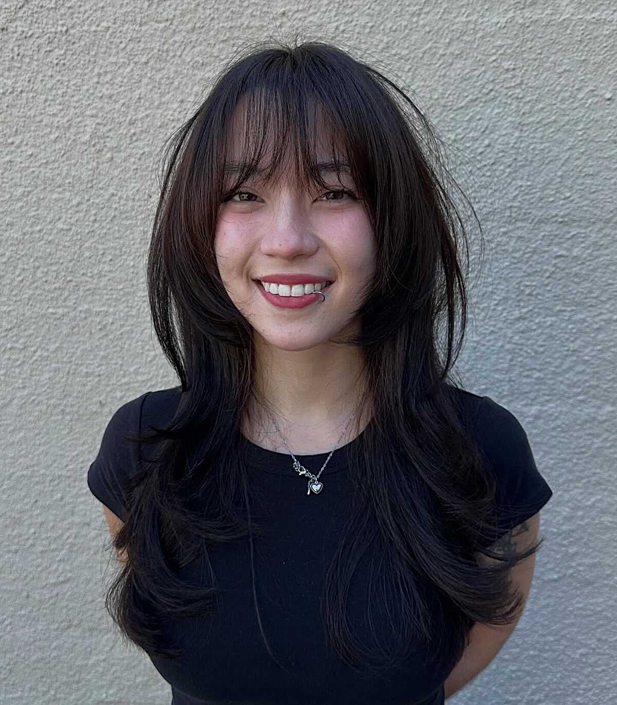 Long black hush cut with airy wispy bangs and volume