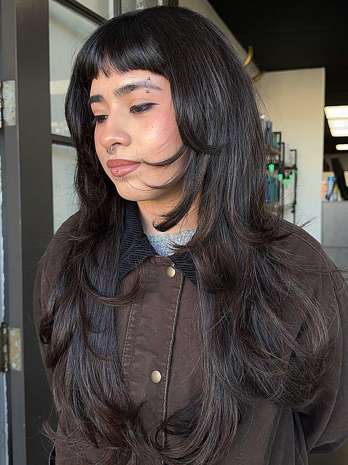 Long black hush cut with short micro bangs and layers