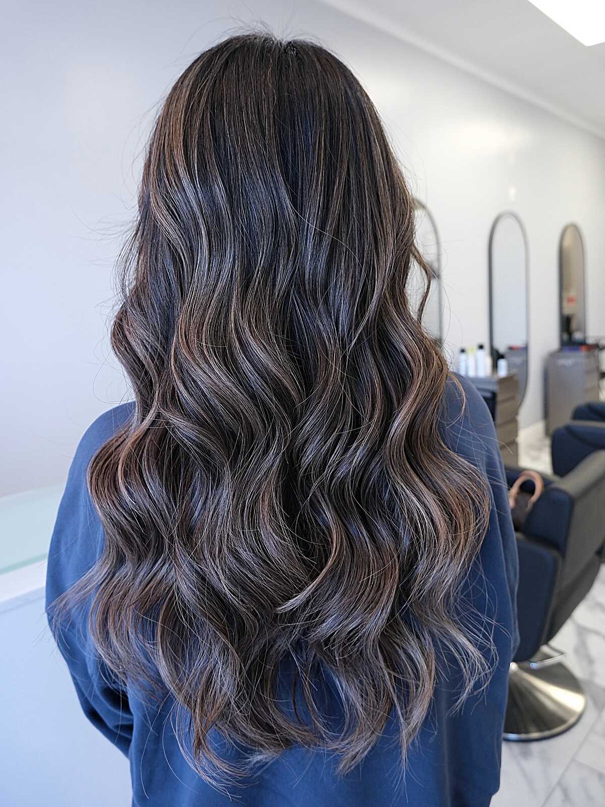 Long dark wavy hair with cool-toned ashy babylights