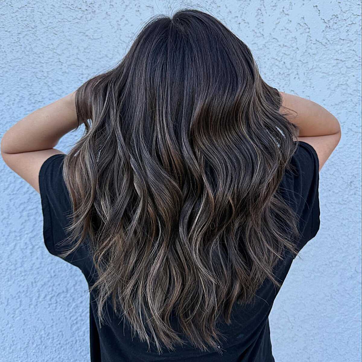 Nearly black wavy hair with peppery ash babylights