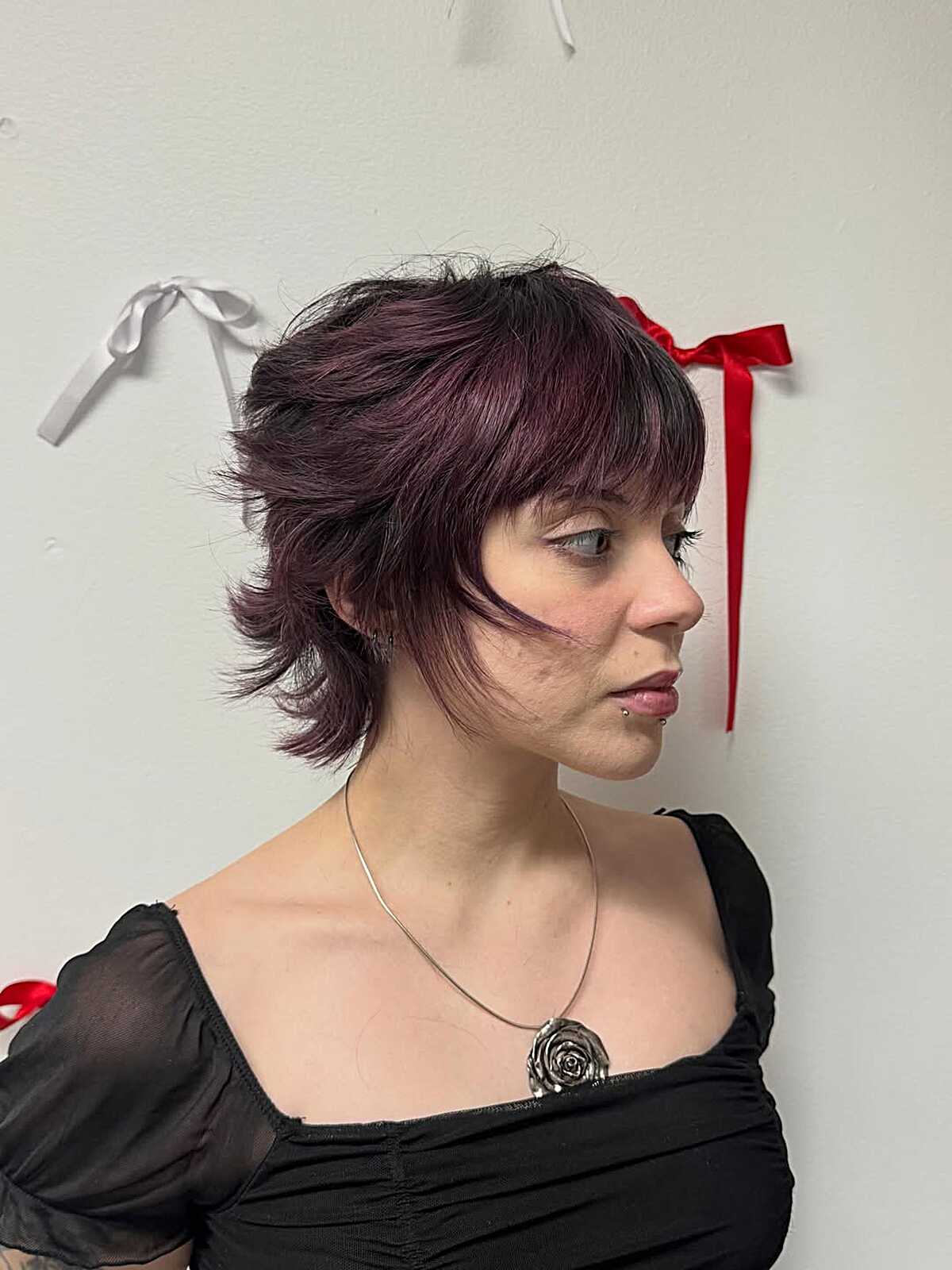 Plum colored short shag with face-framing tendrils