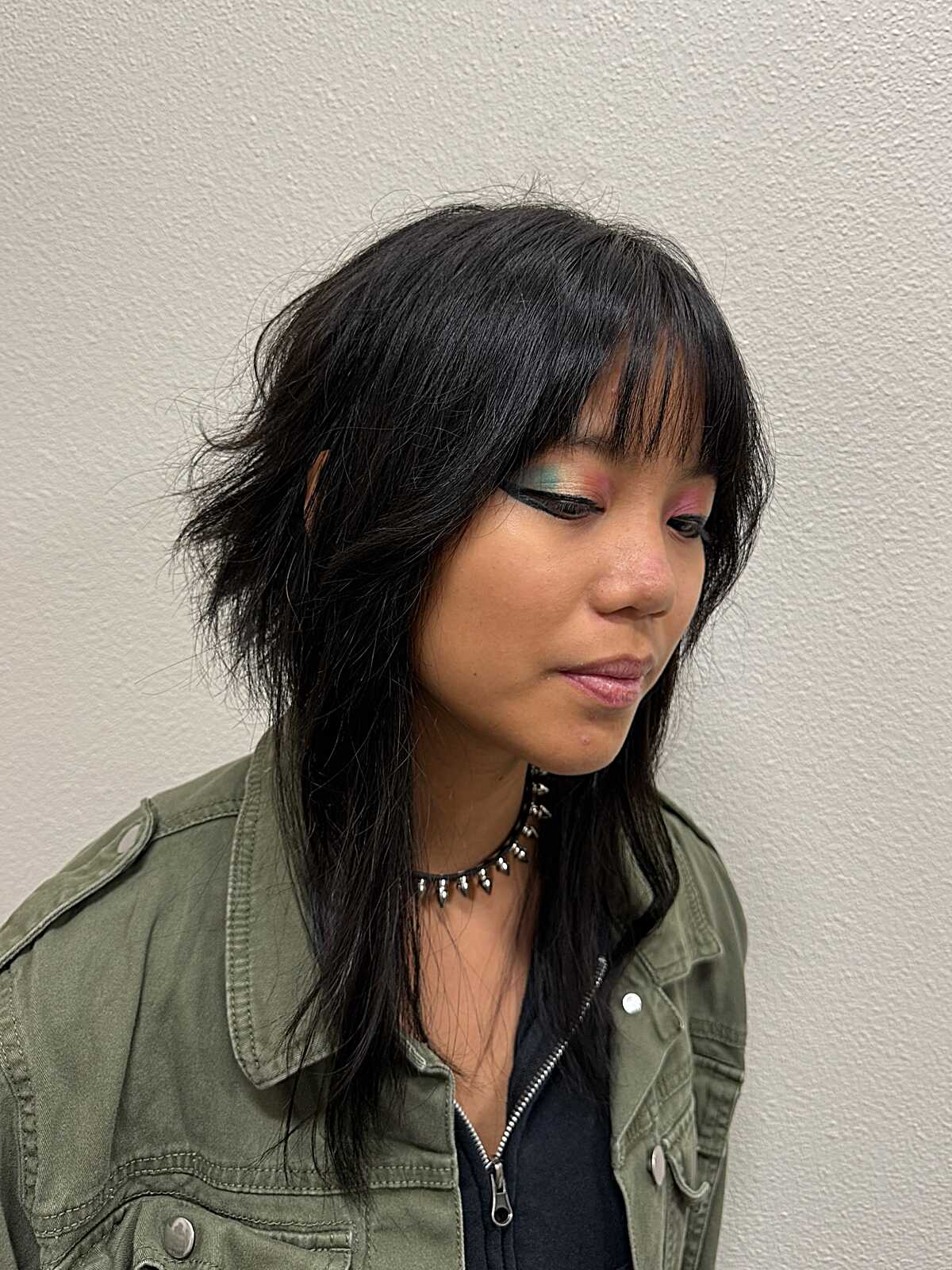 Black razor-cut shag with wispy side-swept fringe