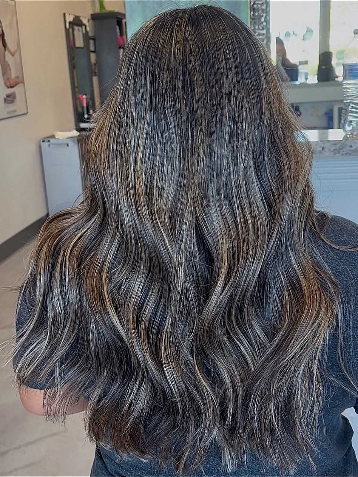 Dark wavy hair with scattered ashy babylights throughout