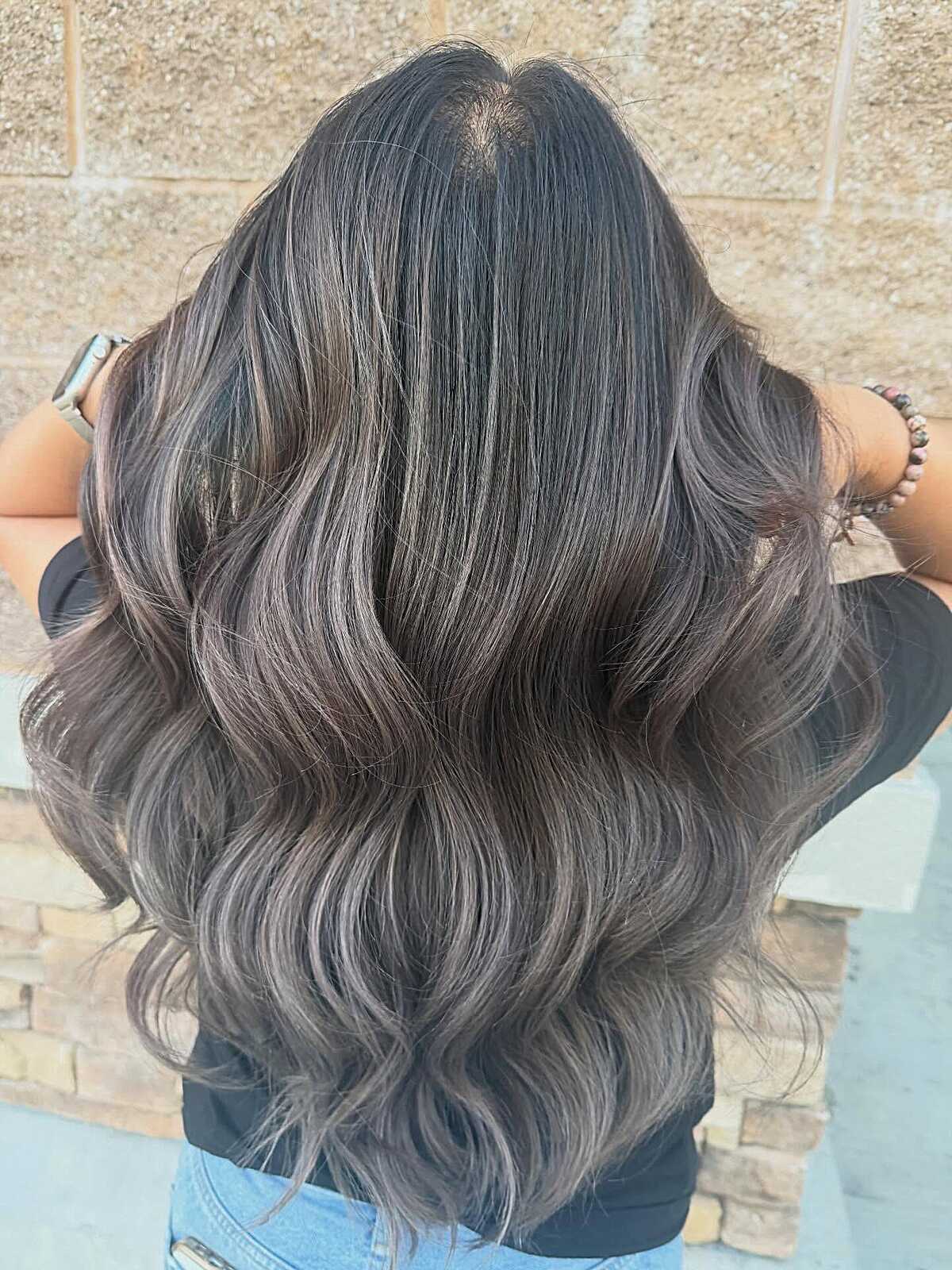 Jet black wavy hair with silver-toned ashy babylights