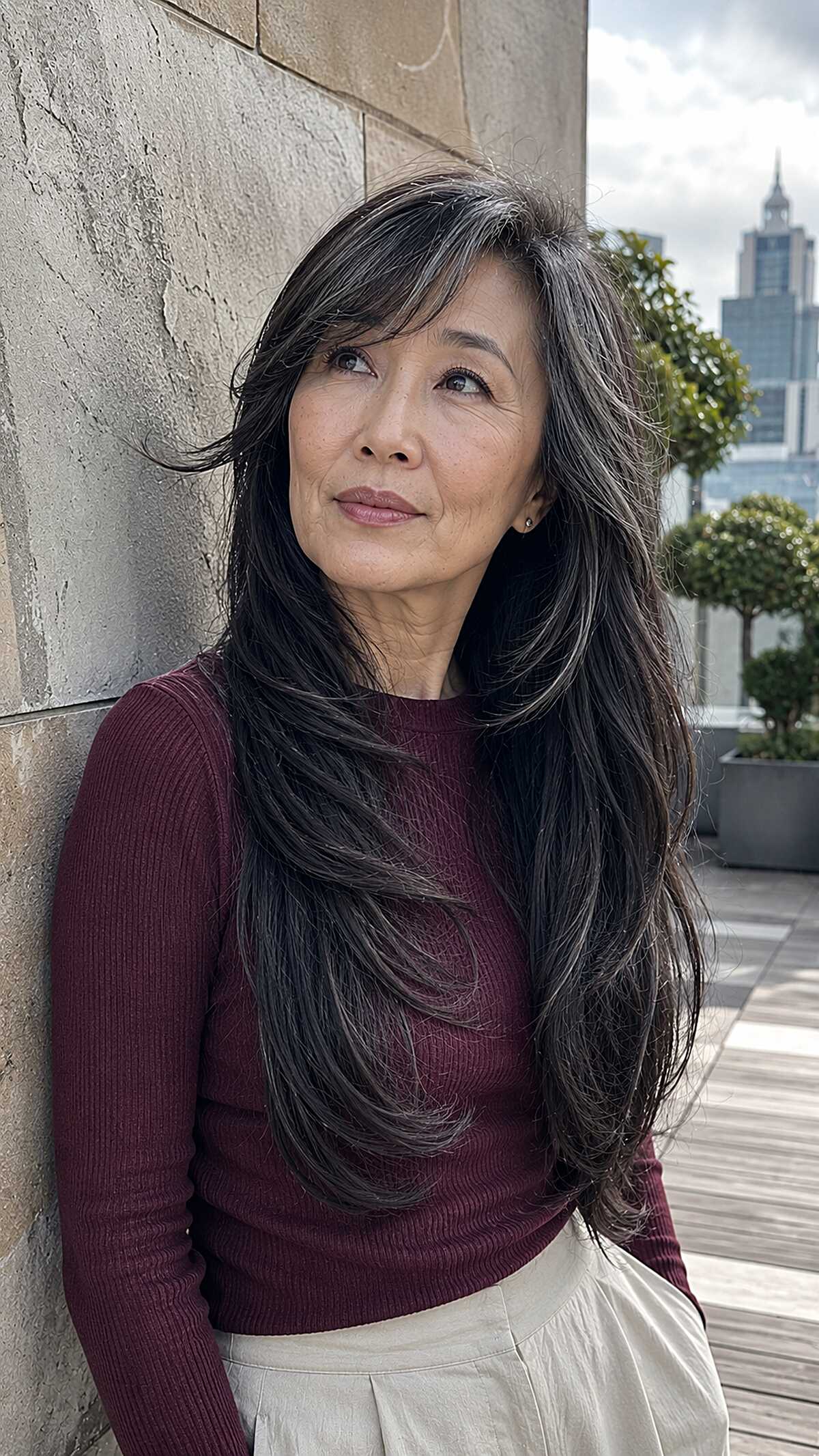 Silver-streaked long black hair with windswept layers