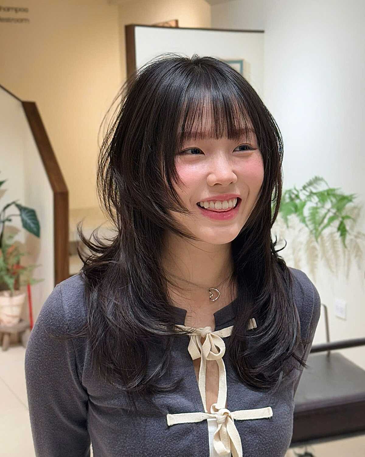 Medium-length black hush cut with wispy see-through bangs